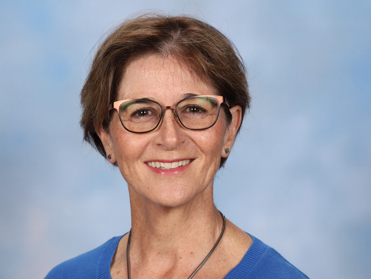 a person in blue shirt and glasses